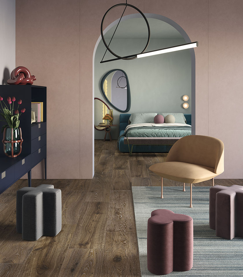 Chambre moderne avec sol effet bois, murs rose poudré et mobilier aux formes arrondies.