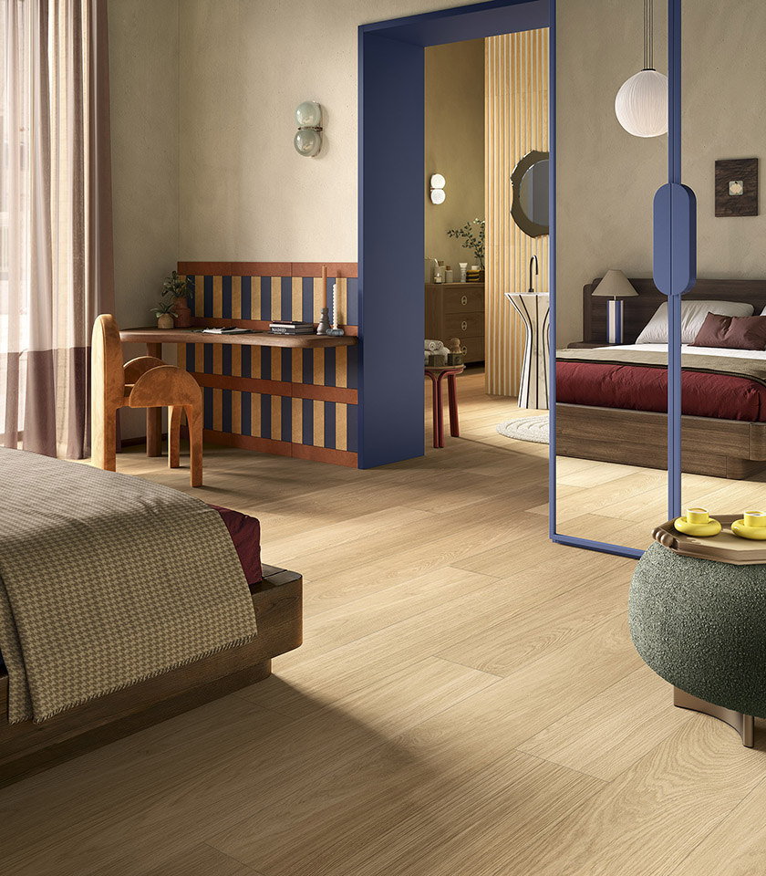 Bio Charme Golden interprète la chaleur du chêne dans une surface céramique lumineuse et naturelle, idéale pour des chambres accueillantes au design contemporain.