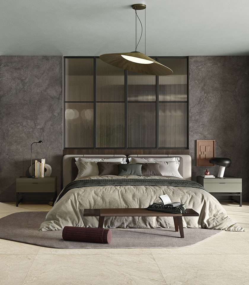 Chambre contemporaine avec sol beige effet pierre, murs sombres texturés et mobilier aux tons neutres.